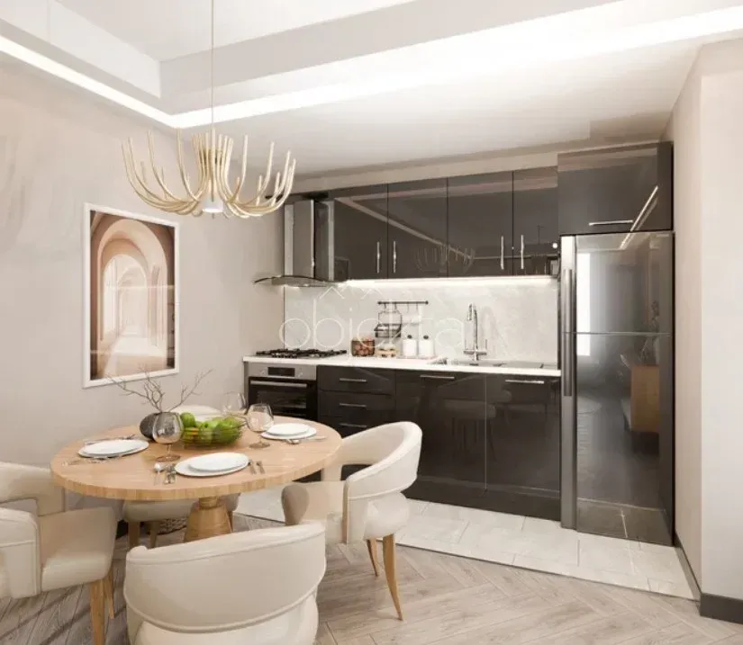 Modern kitchen with a dining area and dark kitchen cabinets.