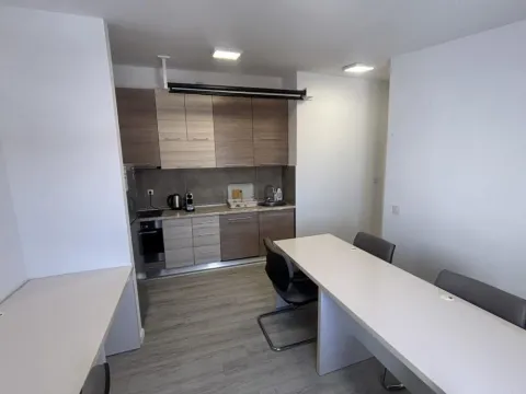 Kitchen equipped with wooden cabinets and appliances, connected with office desks. - image 11