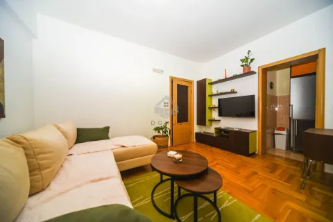 Living room with a sectional sofa, coffee table, and wall-mounted TV. - image 28
