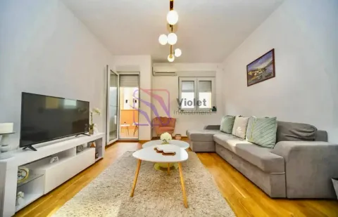 Living room with a sectional sofa, TV, and access to the terrace. - image 2