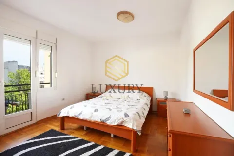 Furnished bedroom with a double bed, wooden furniture, and access to the terrace. - image 8