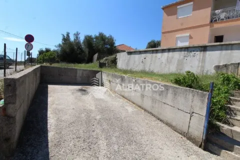 Concrete yard and access to the building with a fence. - image 5