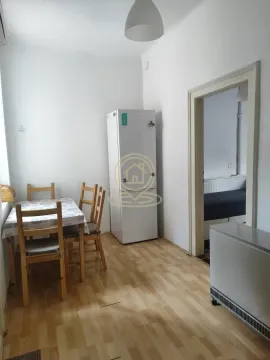 Smaller kitchen with a dining table and a refrigerator. - image 8
