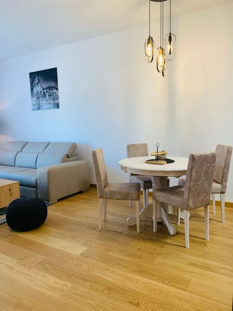 Living room with a sofa and dining table.