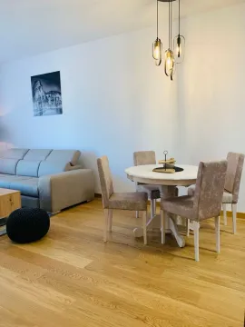 Living room with a sofa and dining table. - image 3