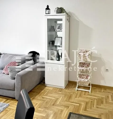 Living room with a sofa and a white display cabinet.