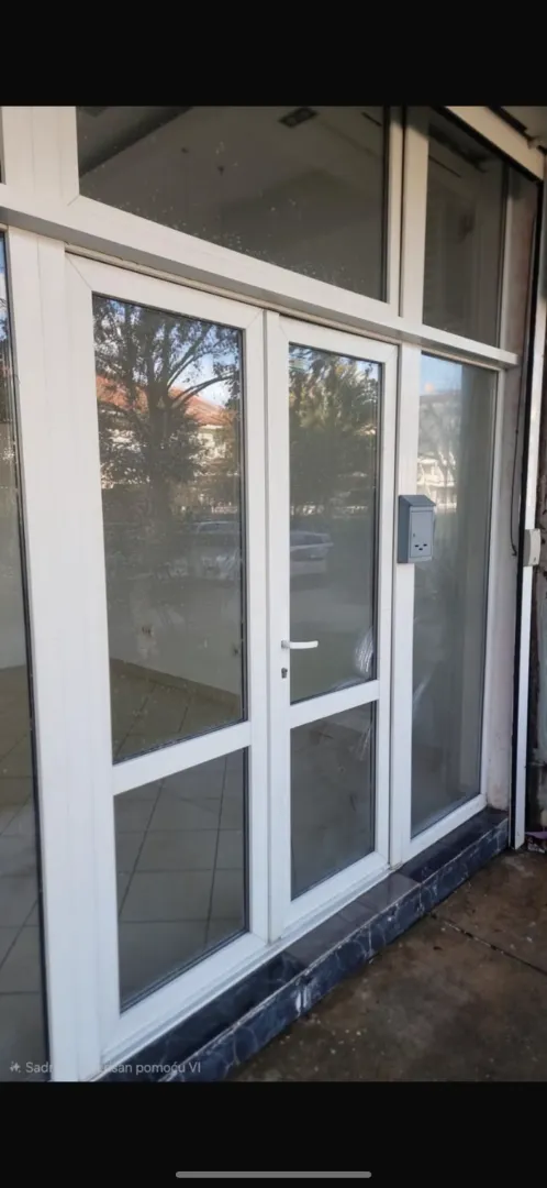 Entrance door and glass facade of the commercial space.