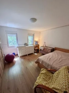 Bedroom with a double bed, baby crib, and chest of drawers. - image 12