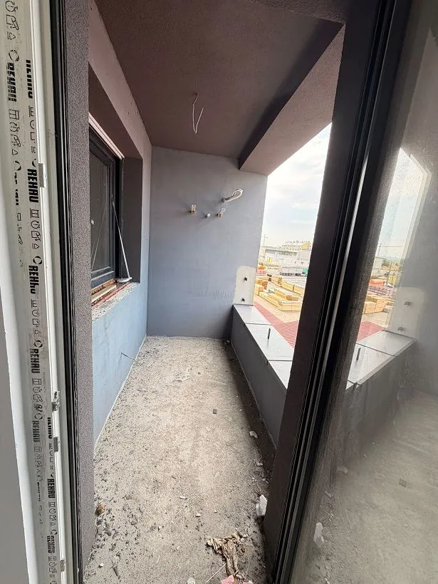 Unfurnished balcony with gray walls in a building under construction.