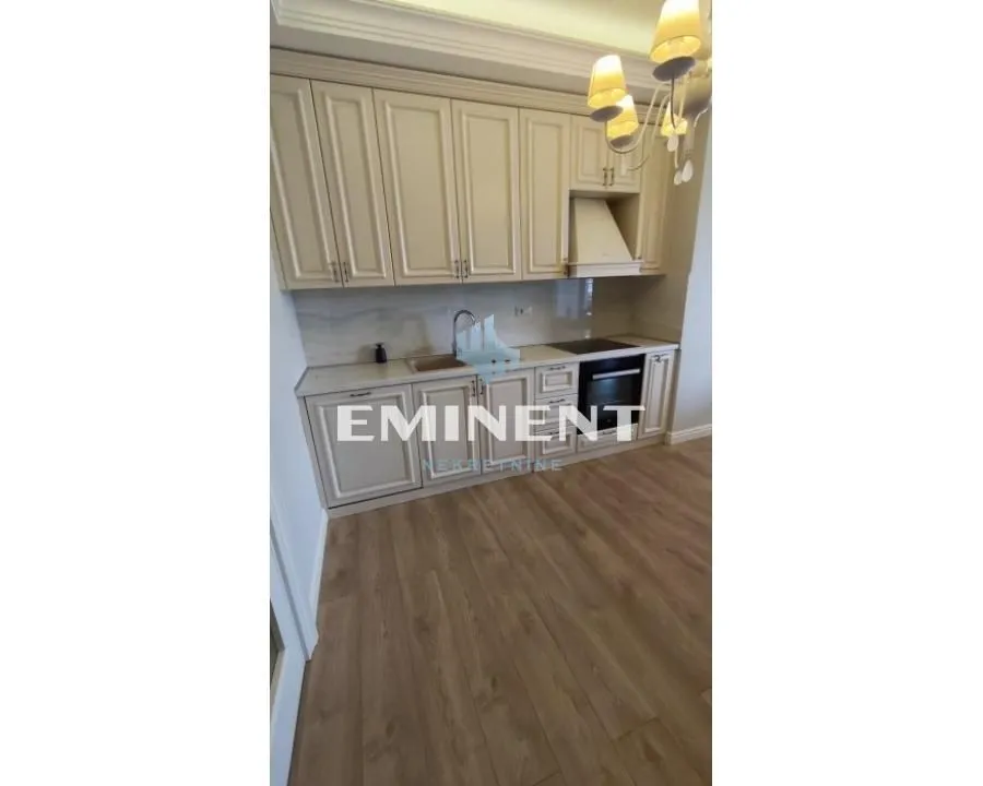 Kitchen with light wooden cabinetry and parquet flooring.