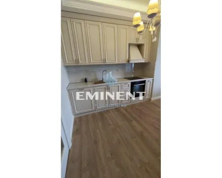Kitchen with light wooden cabinetry and parquet flooring. - image 7