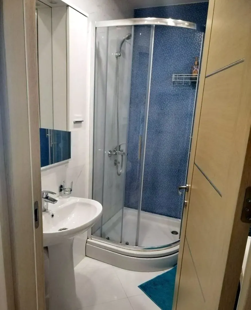 View of a modern bathroom with a shower cabin.