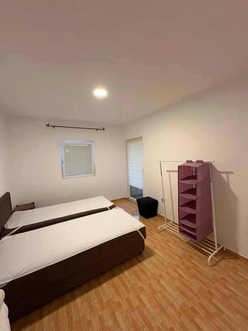 Bedroom with two beds and a wardrobe.