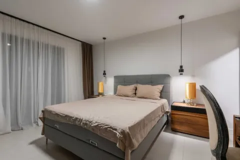Modern bedroom with a double bed, nightstands, and curtains. - image 9