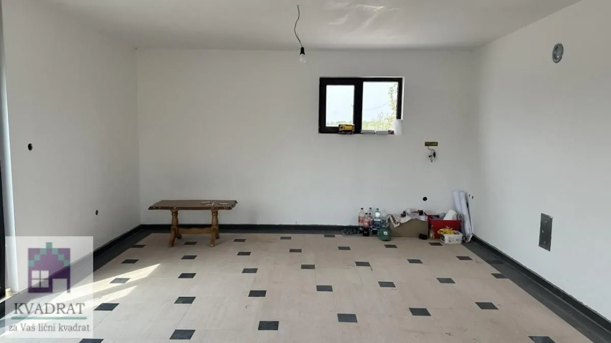 Empty room with tiled flooring and a window.