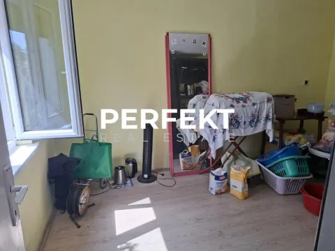 Prikaz prostorije sa laminatnim podom i različitim predmetima unutar nekretnine. - image 5