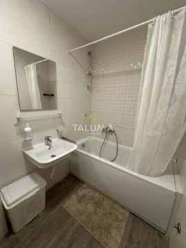 Bathroom equipped with a bathtub, washbasin, mirror, and a white shower curtain. - image 7