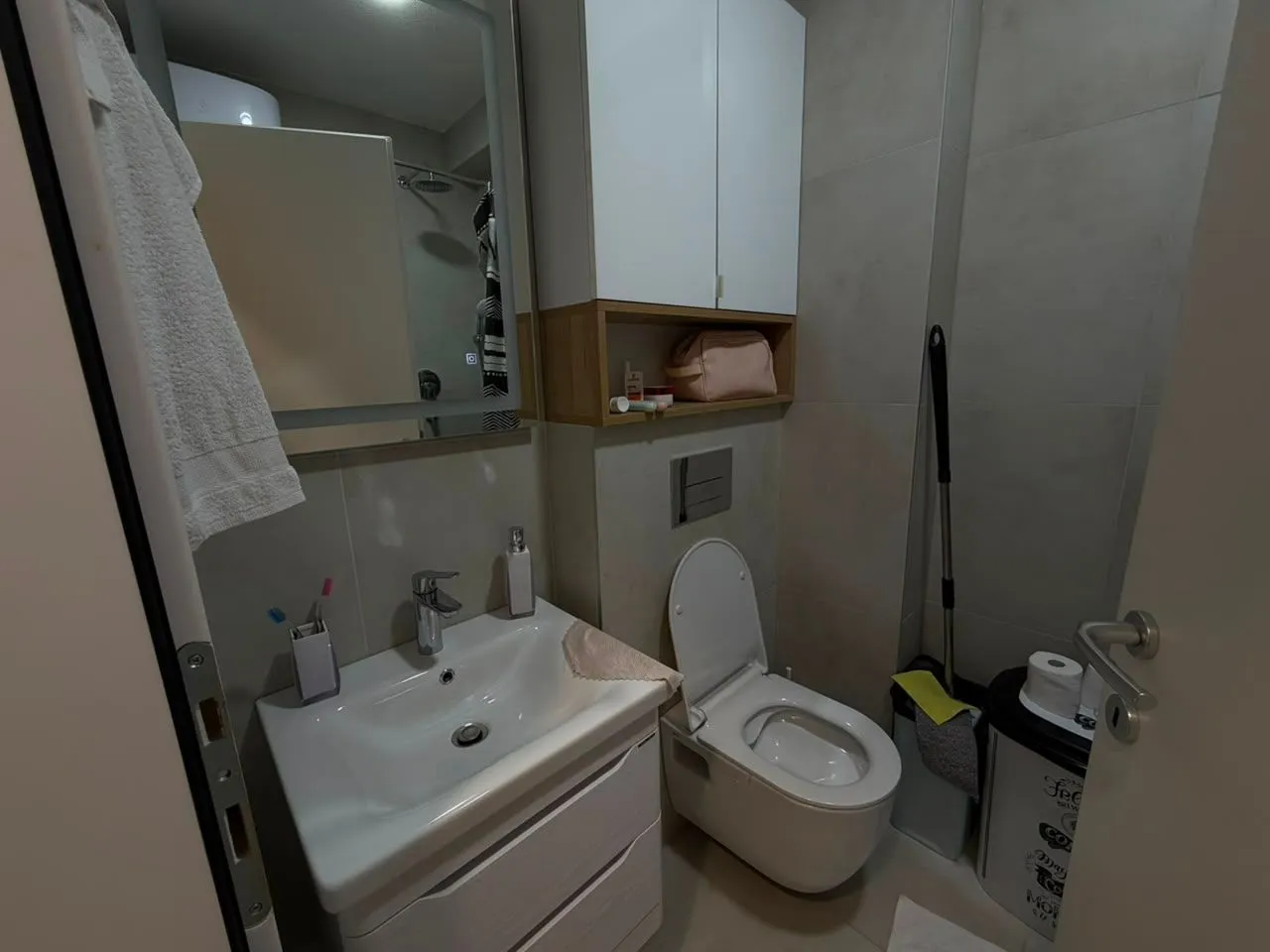 Small bathroom with a sink, toilet, and wall-mounted cabinet.
