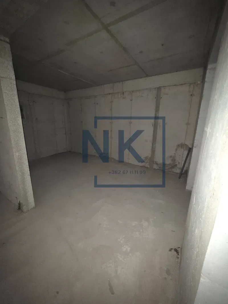 View of an unfurnished room in rough construction condition.