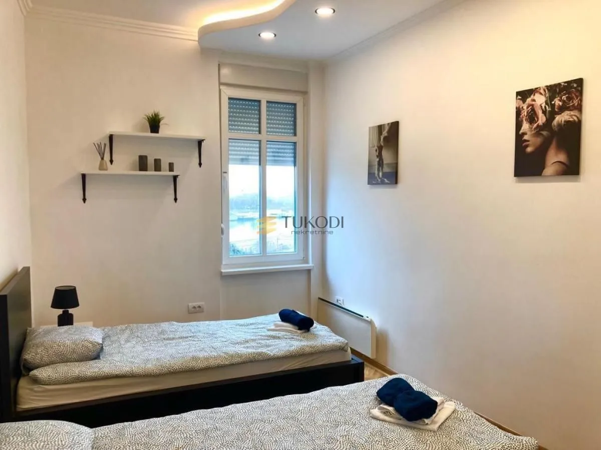 Bedroom with two beds and a window.