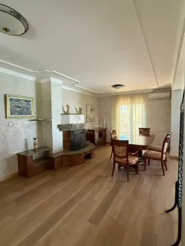 Living room with dining area, fireplace and wooden floor. - image 2