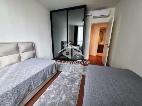 Bedroom with two beds and a large built-in wardrobe. - image 11