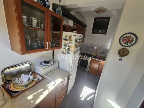 Small kitchen with wooden cabinets, refrigerator, and stove. - image 7