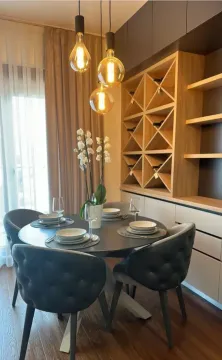 Dining area with a table, chairs, and built-in shelving units in the interior. - image 5