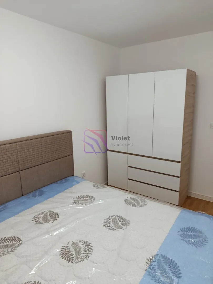 Bedroom with a double bed and a wardrobe.
