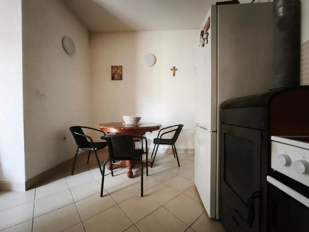 Kitchen with a dining table and chairs.