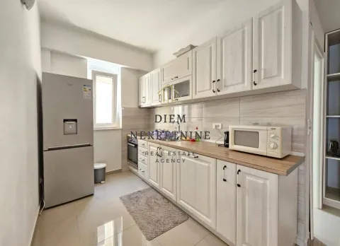 Small kitchen with white cabinets and a refrigerator. - image 10