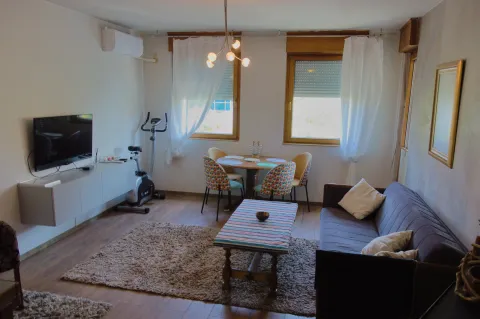 Living room with sofa, dining table, and TV. - image 2
