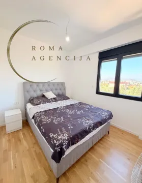 Bright bedroom with a double bed and a window with a view. - image 8