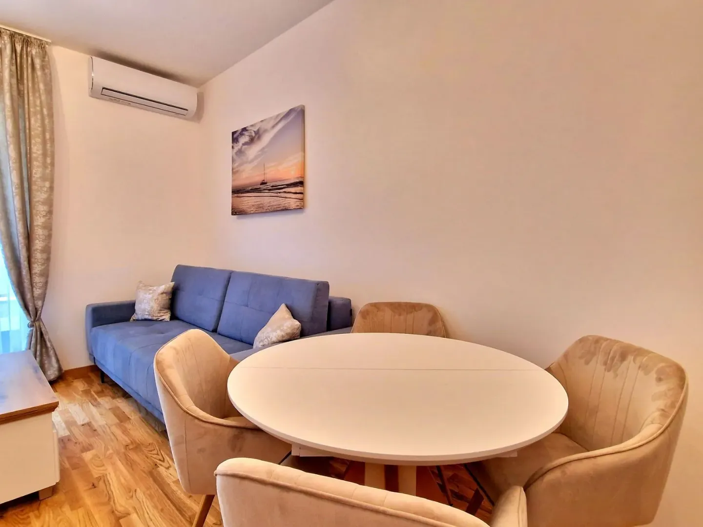 Living room with a sofa and a dining table.