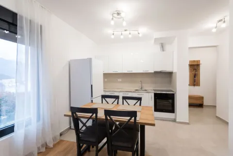 Modern kitchen with a dining area and white cabinetry. - image 4