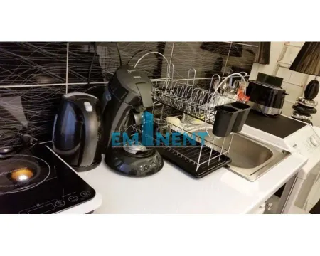 Part of the kitchen with a sink, hob, and home appliances. - image 10