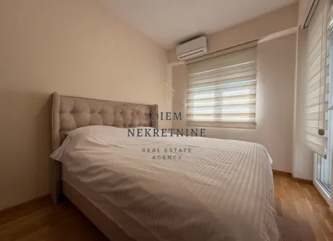 Furnished bedroom with a double bed and a window. - image 8