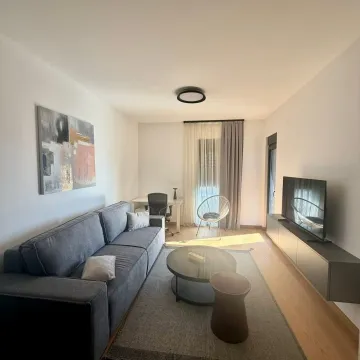 Modern and bright living room with a sofa, coffee table, and TV. - image 5