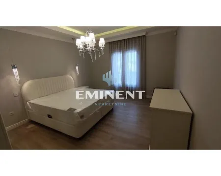 Spacious bedroom with a double bed and a chandelier. - image 9