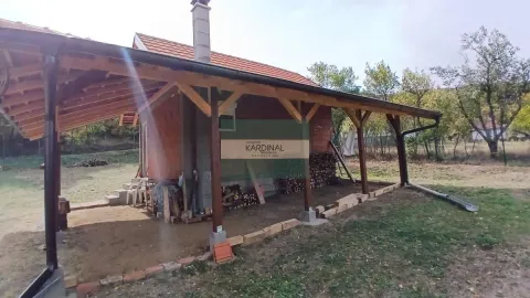 Pogled na spoljašnjost kuće sa natkrivenom drvenom terasom i dvorištem. - image 13