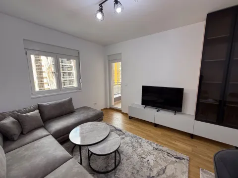 Living room with a sectional sofa, TV, and access to the terrace. - image 9