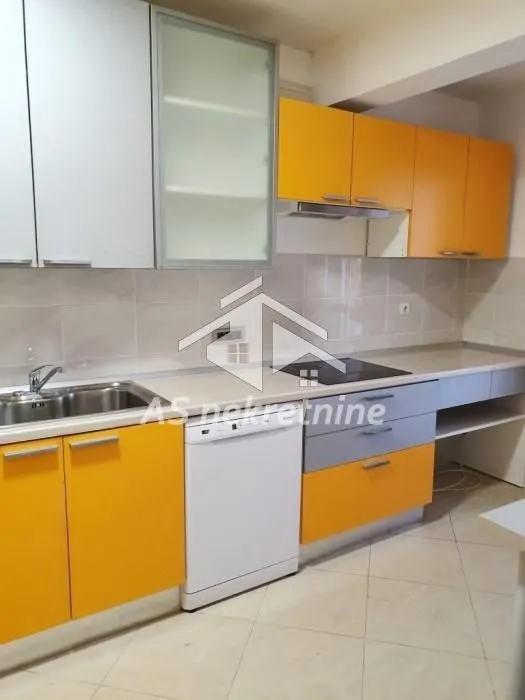 Kitchen with orange and grey cabinets and built-in appliances.