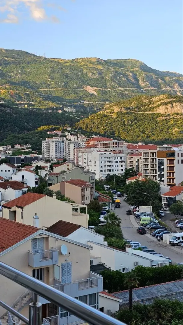 View from the terrace overlooking the city and mountains in the background.