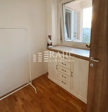 Smaller room with parquet flooring, a chest of drawers, and a window. - image 7