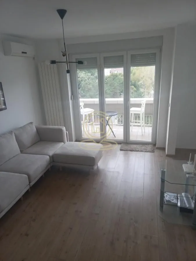 Living room with a sofa and access to the terrace.