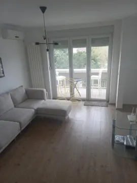 Living room with a sofa and access to the terrace. - image 3