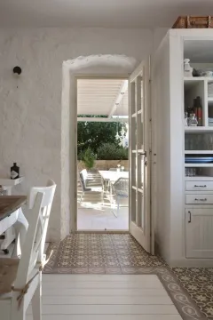 Bright kitchen with a dining area and access to the terrace. - image 4