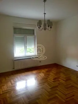 Empty room with hardwood flooring, a window, and a chandelier. - image 5