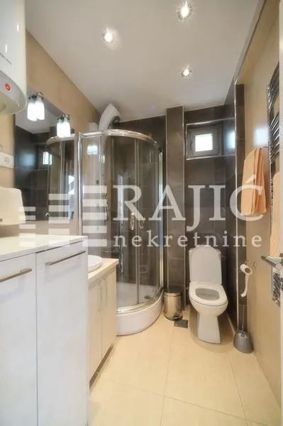 Modern equipped bathroom with a shower cabin.