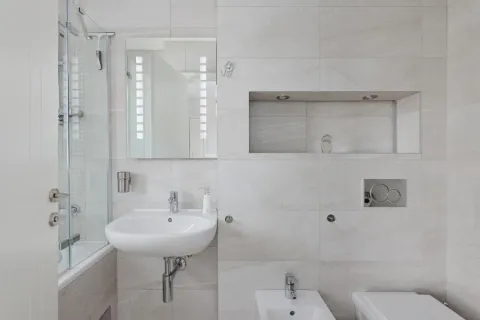 Modern bathroom equipped with a washbasin, mirror, and sanitary fixtures. - image 11